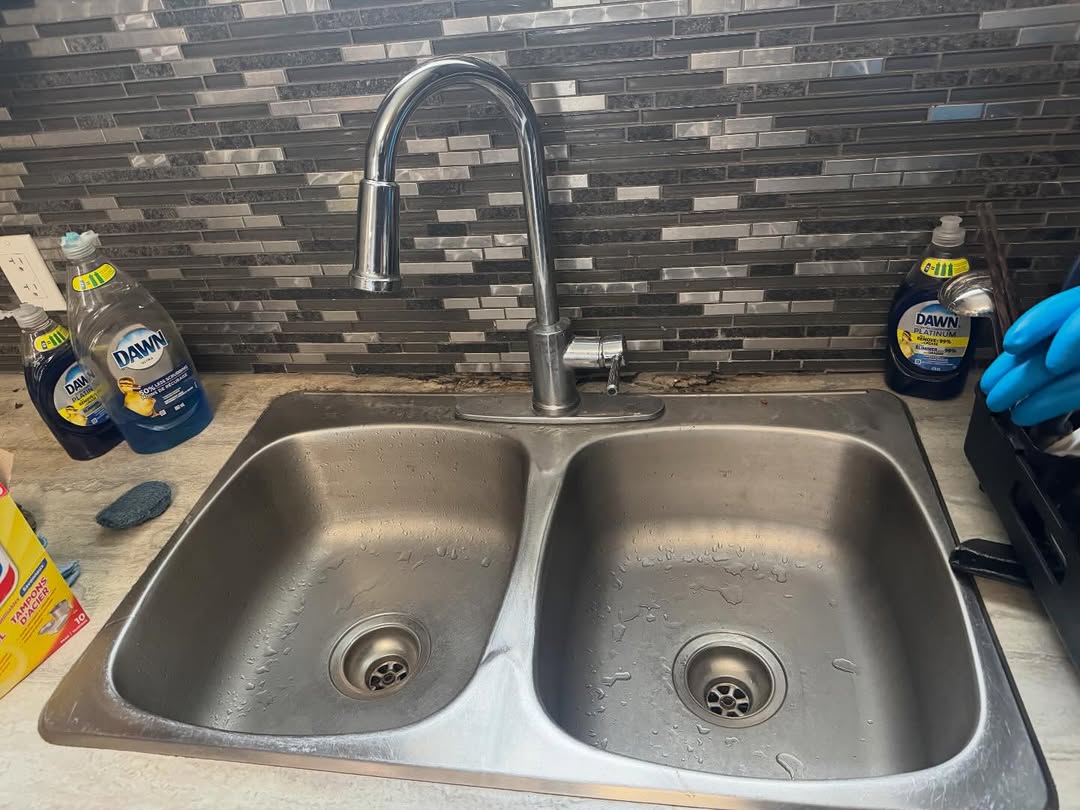 Polished kitchen sink after a student housing clean